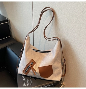 Detail of retro canvas tote bag showing the textured material and brown leather strap