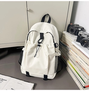 Detail view of large capacity white backpack with black mesh side pocket and drawstring