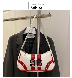 Close-up of white leather underarm bag featuring red stripes, silver rivets and number 96