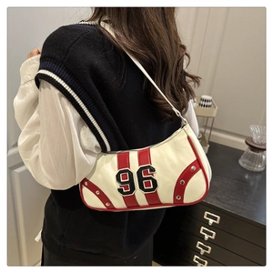 Detail of white PU leather shoulder bag with red stripes and number 96 embroidery