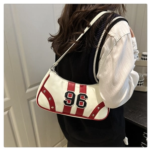 Detail view of a vintage white bowling bag with red stripes and number 96 embroidery