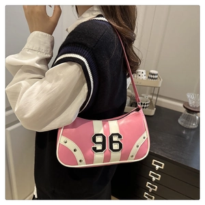Detail view of pink PU leather underarm bag with silver rivets and 96 patch embroidery