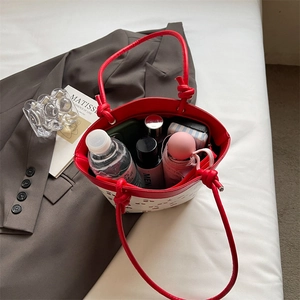 Contrast cherry print bucket bag showing spacious interior with everyday essentials