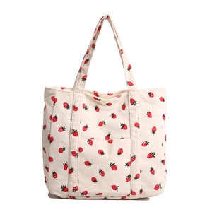 Minimalist corduroy tote bag with strawberry print and long shoulder straps