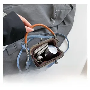 Detail view of denim doctor bag interior showing capacity for phone and cosmetics