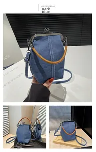 Detailed view of dark blue denim bucket bag featuring retro clasp and brown handle