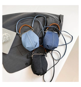 Detailed view of vintage denim shell bags in light blue, medium blue, and charcoal black
