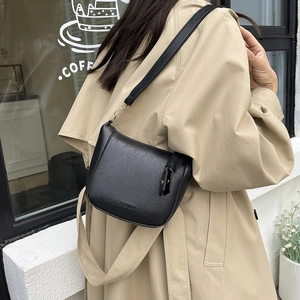 Chic black vintage bucket bag with wide strap and fashion embossing for women