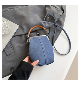 Detail of vintage denim bucket bag featuring contrast stitching and metal clasp closure