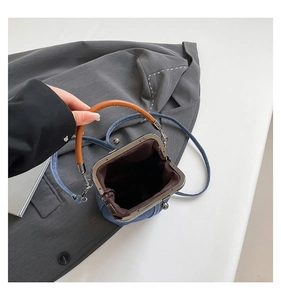 Top view of vintage denim bucket bag showing brown leather interior and metal clasp closure