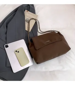 Brown leather tote bag with chain strap styled with professional office accessories
