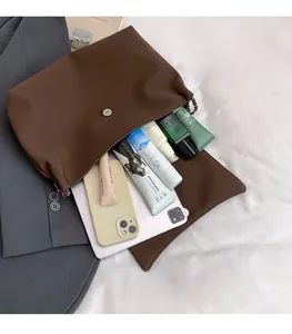 Macro shot showing the spacious interior of the brown PU leather tote with tablet and cosmetics