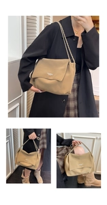 Detail of khaki leather shoulder bag showing woven chain strap and minimalist flap design