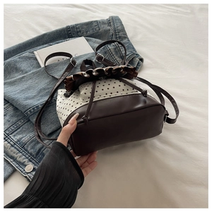 Detail of Korean style mini bucket backpack with star print and brown leather base