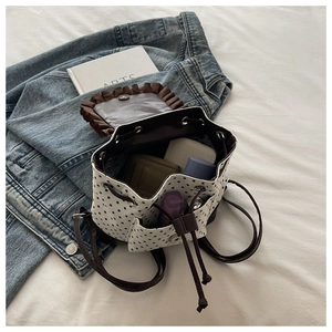 Detail of star pattern drawstring backpack with interior space for wallet and cosmetics
