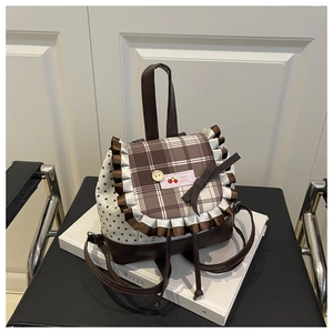 Detail of a mini star-print backpack featuring brown ruffles and cherry embroidery