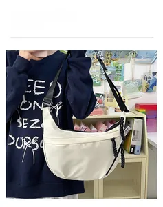 Detailed view of the white crescent nylon crossbody bag with black adjustable strap