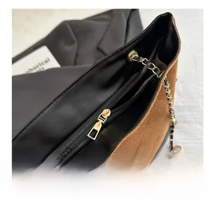 Detail view of smooth metal zipper and quilted texture on a vintage bucket bag