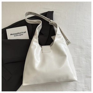 Top view of off-white rivet shoulder bag with adjustable strap and metal buckles
