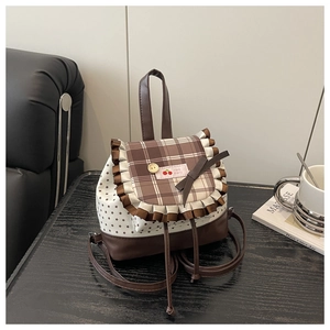 Detail of sweet star pattern backpack with cherry patch and brown ruffled plaid flap