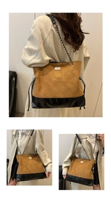 Detail of vintage quilted velvet tote bag with chain strap and contrast leather panels