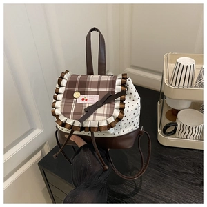 Detail of ballet style plaid lace backpack with bow and star print texture