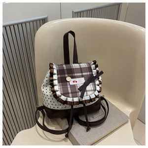 Detail of cute plaid mini backpack with lace edges, cherry patch and bow decoration