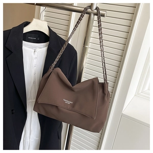 Detail of dark brown leather shoulder bag with chain strap and fashion logo print