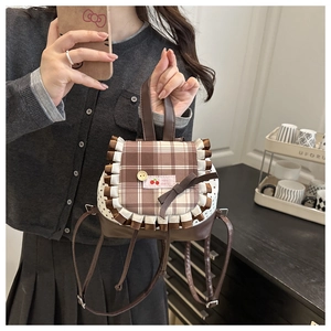 Detailed view of brown plaid mini backpack with lace trim and bow knot decoration