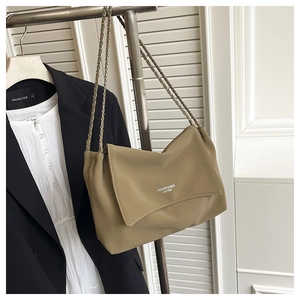 Close-up of khaki leather shoulder bag featuring chain strap and fashion logo