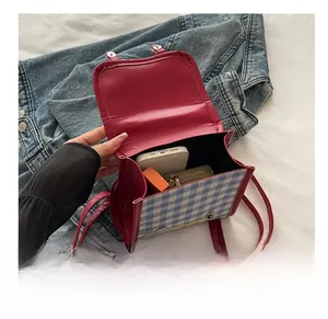Internal view of blue plaid crossbody bag showing storage capacity for daily essentials