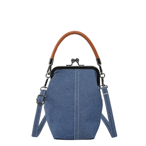 Retro denim bucket bag with white contrast stitching and brown leather handle