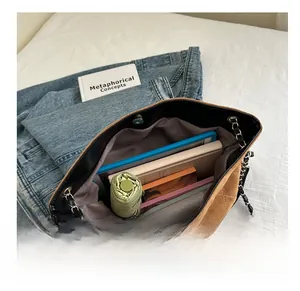 Detailed view of spacious brown suede quilted tote bag interior holding daily essentials