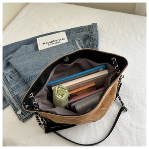 Detailed view of the spacious quilted tote bag interior with everyday essentials