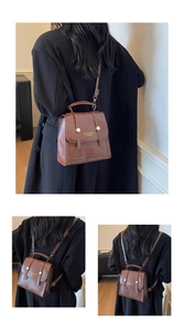 Detail of vintage brown PU leather backpack showing versatile straps and metal buckles