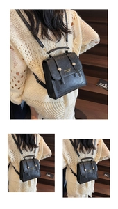 Close-up of retro black faux leather backpack with gold lettering and adjustable straps