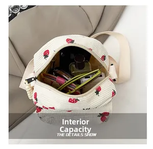 Internal capacity of white corduroy strawberry crossbody bag showing daily essentials