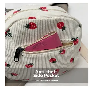 Close-up of the corduroy strawberry bag featuring an anti-theft side zipper pocket
