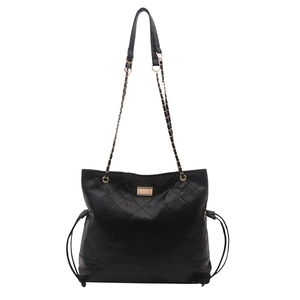 Quilted black tote bag with gold hardware and chain strap on white background