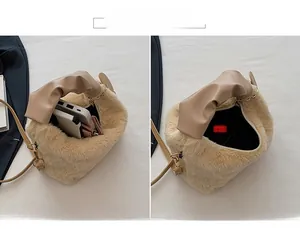 Detail view of the plush beige handbag showing spacious interior for essentials