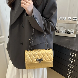 Champagne gold quilted crossbody bag with metal chain strap and luxury lock detail