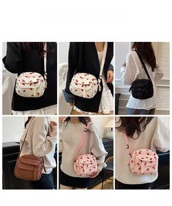 Corduroy mini crossbody bag with strawberry print shown in multiple color options on a model