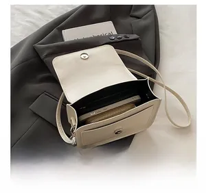Détails de la capacité interne du sac bandoulière en cuir crème avec téléphone et portefeuille