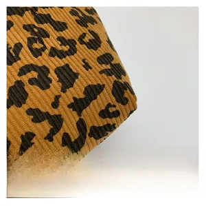 Macro detail of textured leopard print knit fabric with soft ribbed finish and bold spots