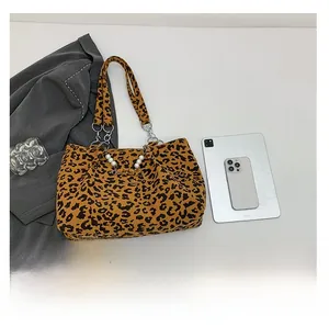 Detail of leopard print corduroy tote with metal chain and pearl handle decoration