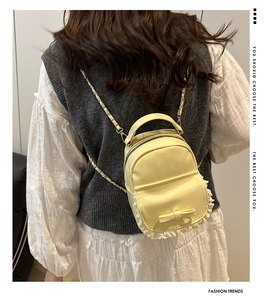 Detailed back view of a yellow mini leather backpack with lace trim and bow accent