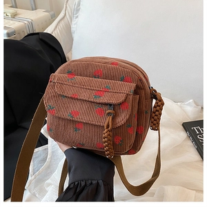 Brown corduroy crossbody bag featuring cute strawberry prints and a front zipper pocket