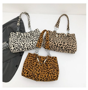 Detailed view of three leopard print corduroy tote bags with pearl and chain accents