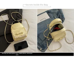 Detail view of mini yellow backpack with bow and lace trim showing interior storage space