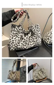 Close-up of leopard print tote bag with corduroy texture and pearl charm details